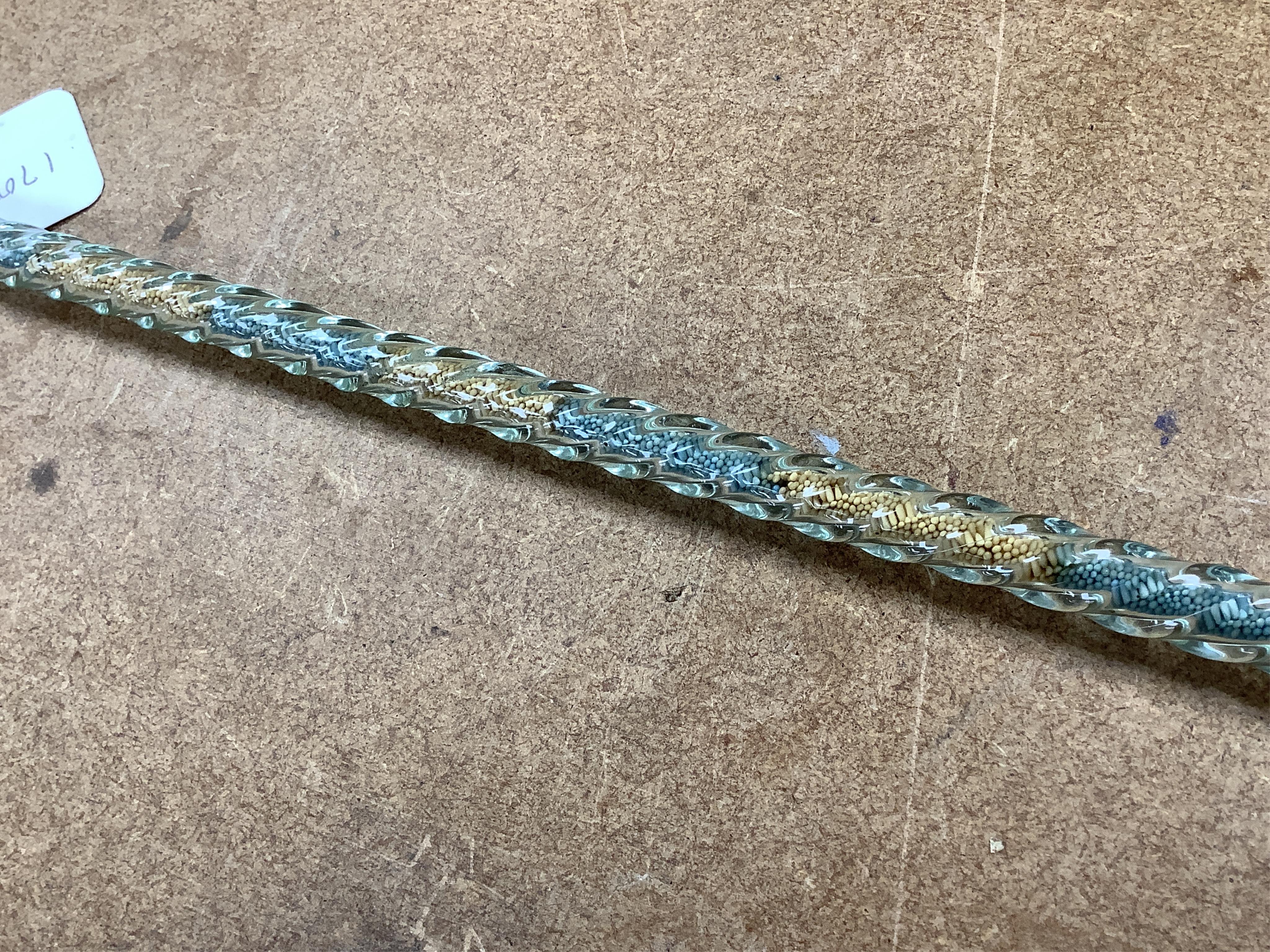 A 19th century Nailsea spiral walking stick, decorated with fine coloured beads, 128cm in length